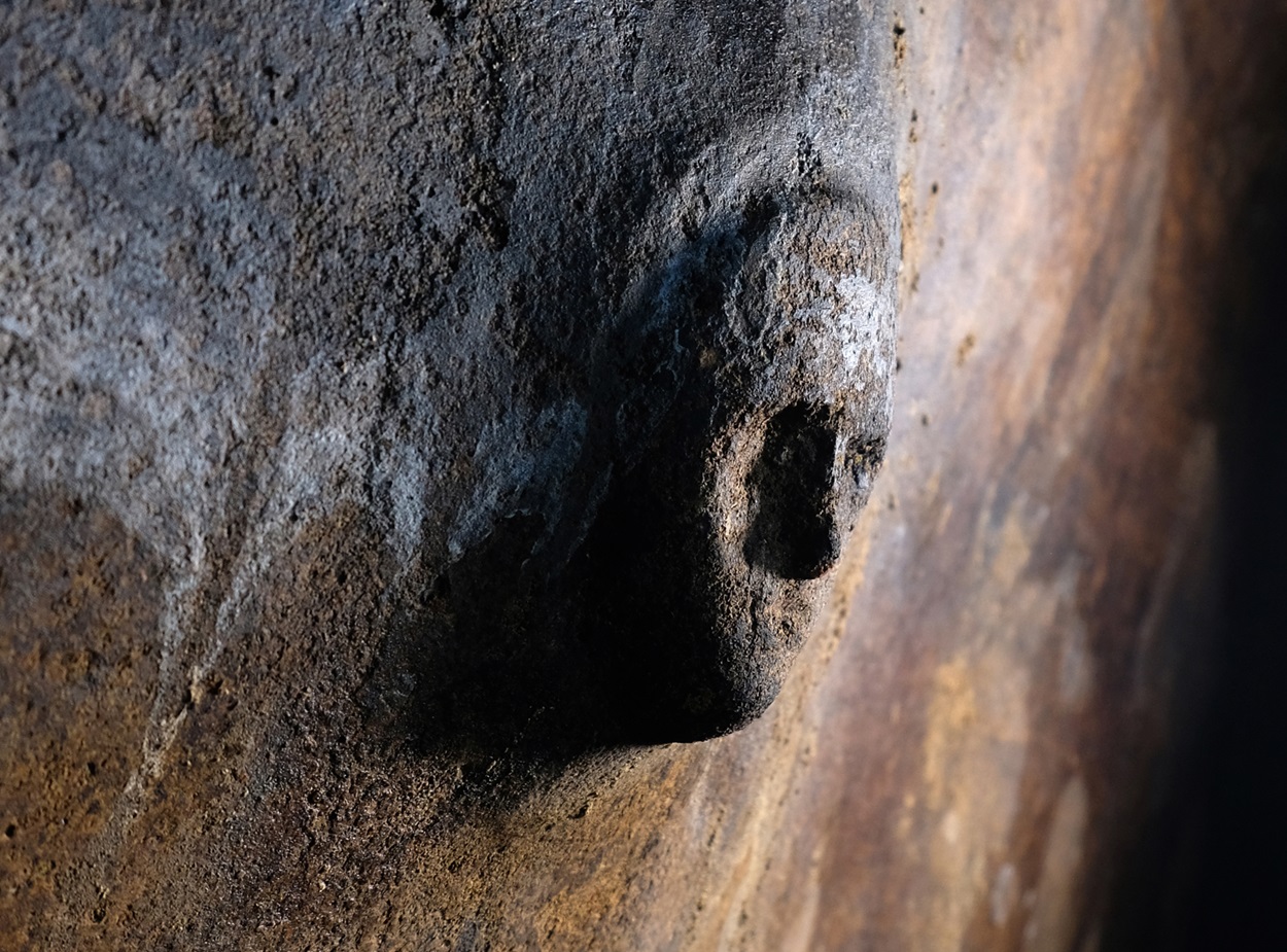 Mysterious stone face discovered on cistern wall