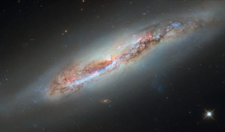 Hubble Captures a Galaxy Leaving a Glowing Trail Through Space