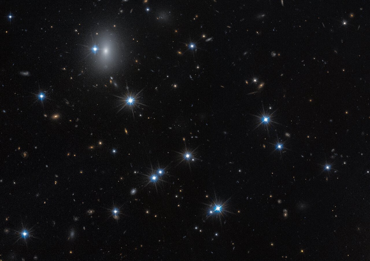 Hubble spots a nearly invisible galaxy in rare image