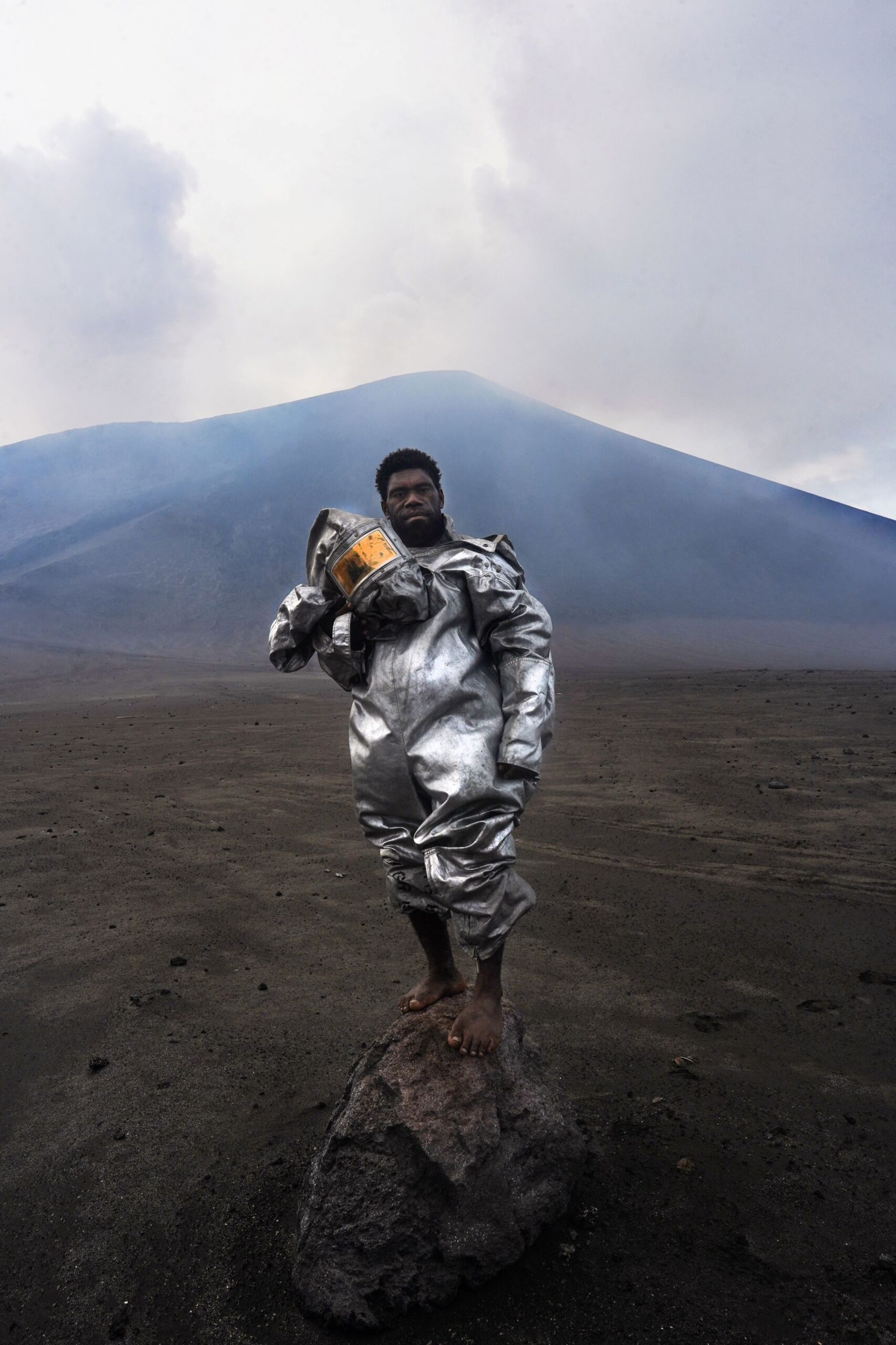Vanuatu’s ‘barefoot volcanologist’ stands at ash- and sulfur-spewing Mount Yasur in award-winning photograph